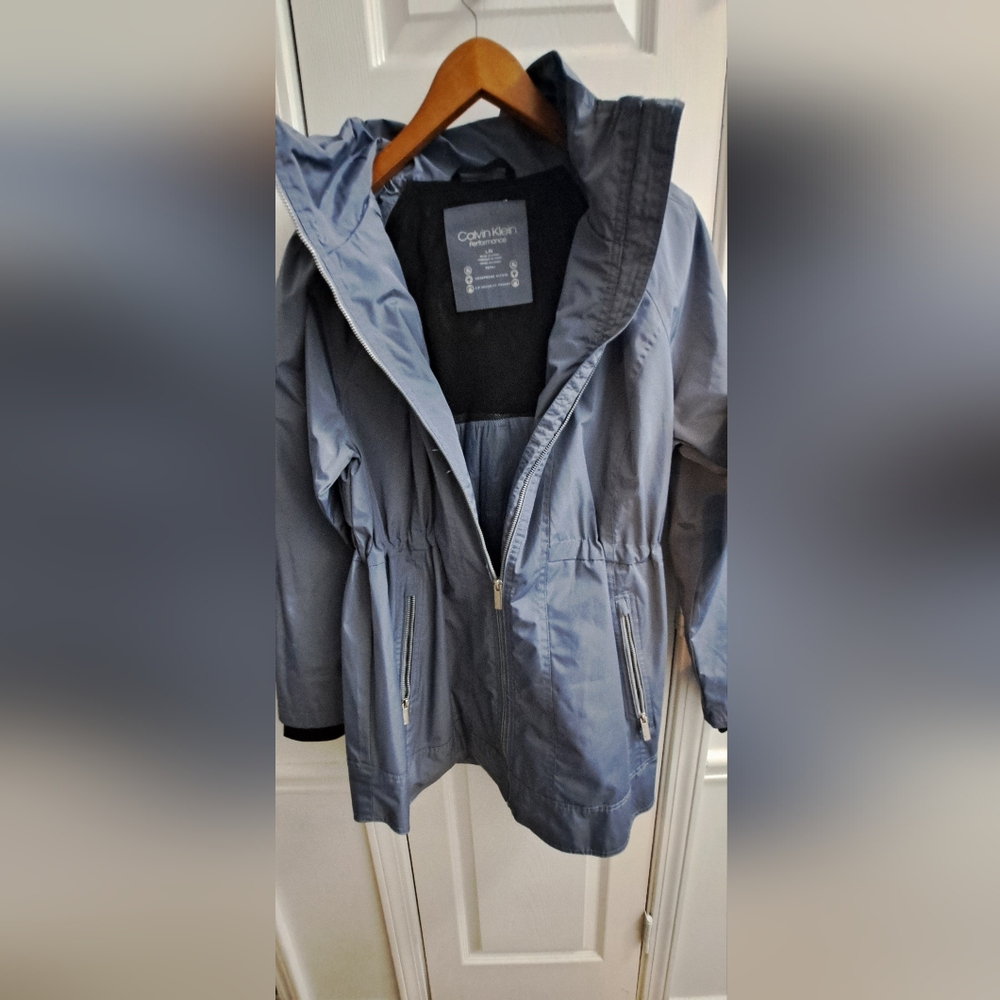 Amazing Calvin Klein raincoat. With a hoody for rainy days or snowy days.